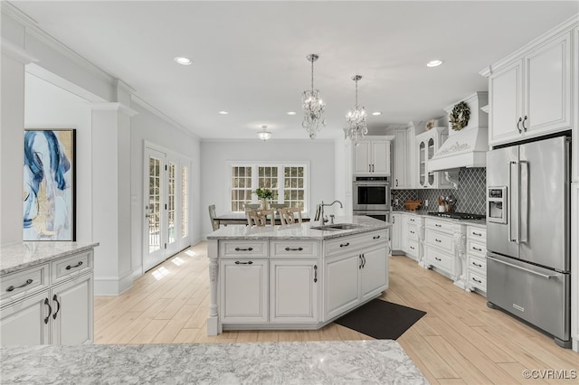 kitchen with light wood-type flooring, white cabinetry, and stainless steel appliances