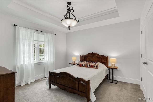 bedroom with light carpet, a raised ceiling, and crown molding