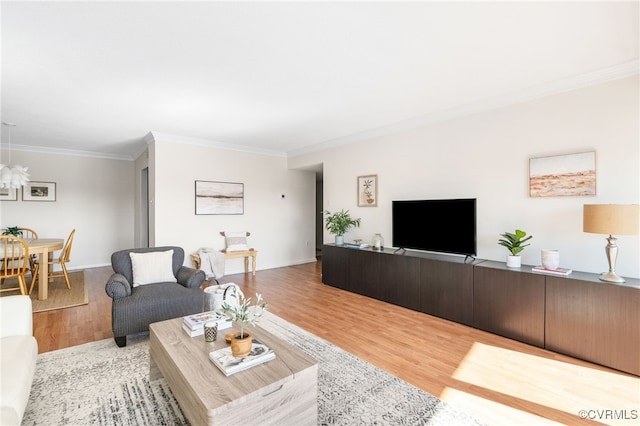 living room featuring hardwood / wood-style flooring and crown molding