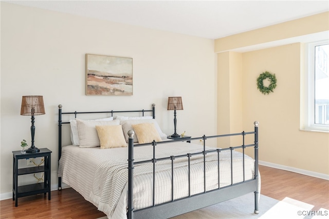 bedroom with wood-type flooring