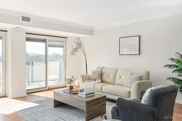 living room with crown molding and light hardwood / wood-style flooring