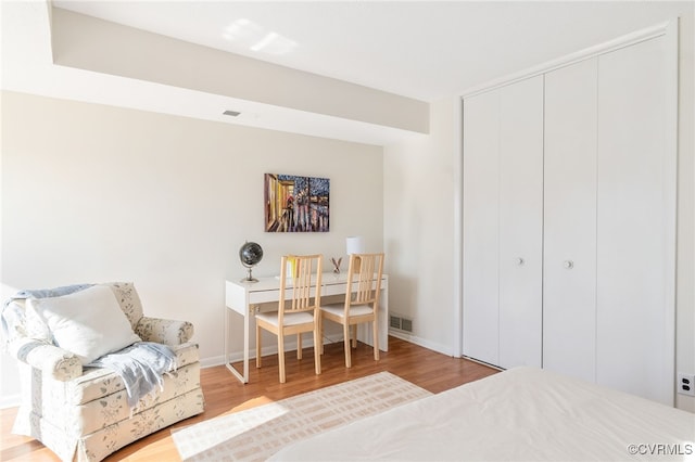 bedroom featuring light wood-type flooring and a closet