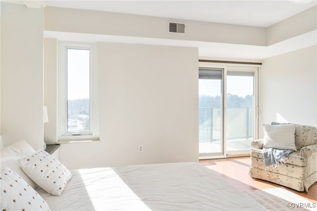 bedroom featuring access to exterior and light wood-type flooring