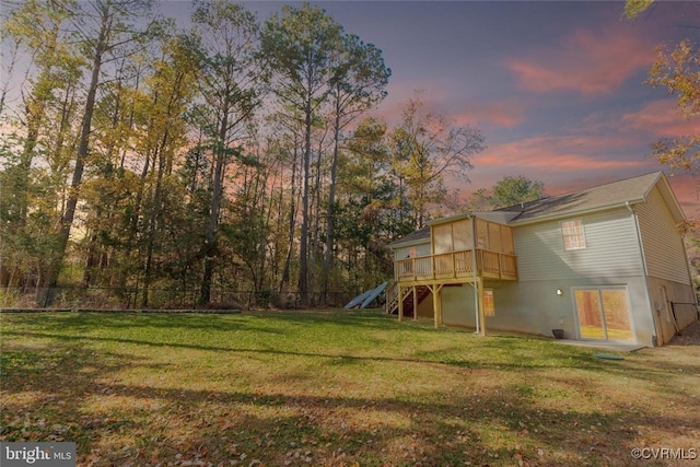 yard at dusk with a wooden deck