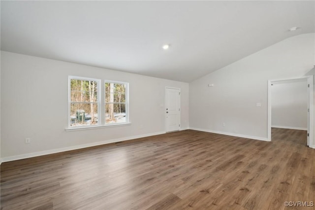 unfurnished living room with dark hardwood / wood-style flooring and vaulted ceiling