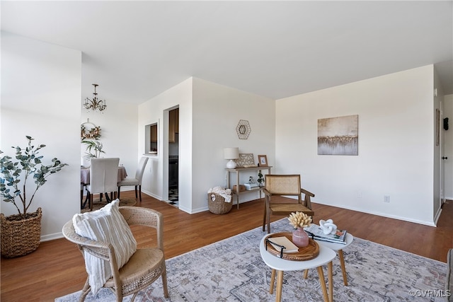 living room with hardwood / wood-style floors and a chandelier