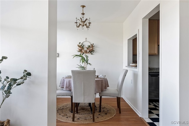 dining space featuring hardwood / wood-style floors and a chandelier