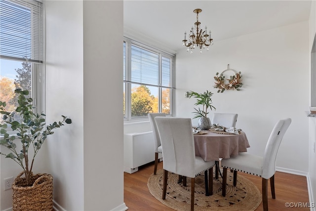 dining room featuring a chandelier and light wood-type flooring