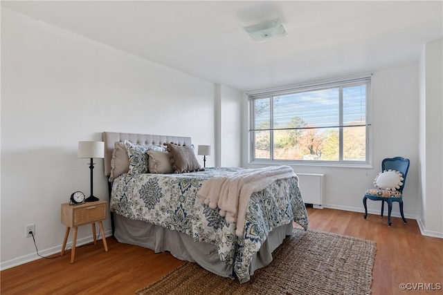 bedroom featuring radiator and wood-type flooring