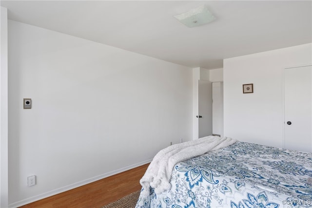 bedroom with hardwood / wood-style flooring