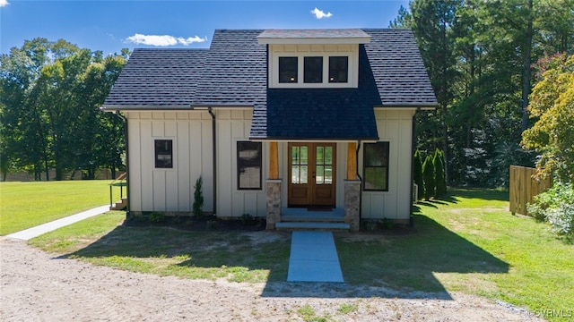 view of front of home with a front yard and french doors