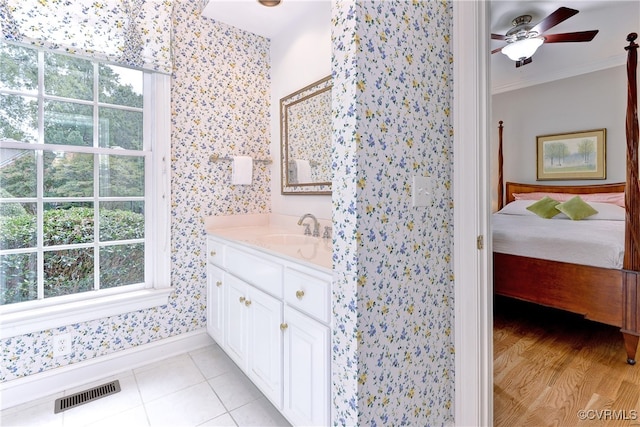 bathroom with crown molding, vanity, wood-type flooring, and ceiling fan