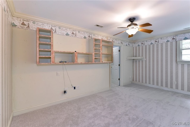 spare room featuring ornamental molding, ceiling fan, and carpet flooring