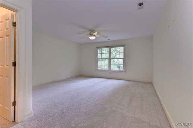 carpeted spare room featuring ceiling fan