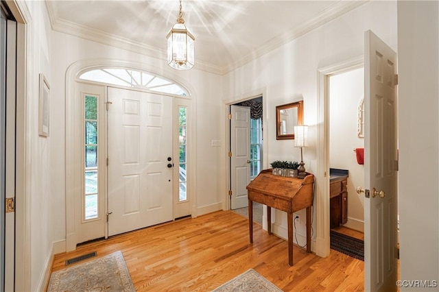 entryway featuring crown molding and light wood-type flooring