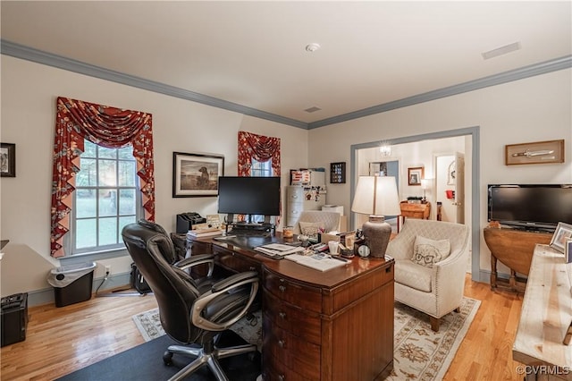 office area featuring ornamental molding and light hardwood / wood-style floors