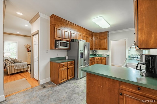 kitchen featuring sink, crown molding, and stainless steel appliances