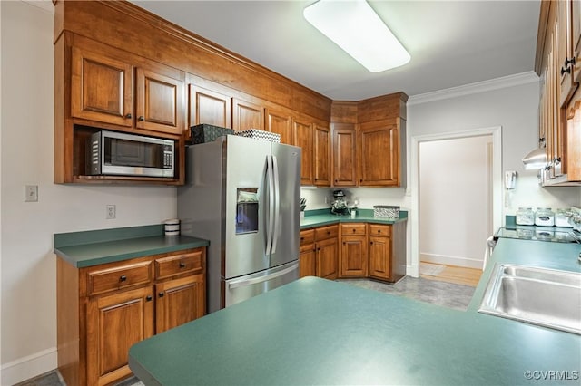 kitchen with ornamental molding, stainless steel appliances, and sink