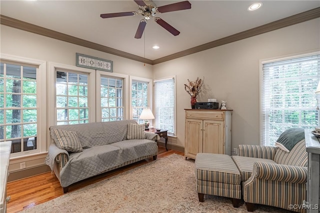 sitting room featuring hardwood / wood-style floors, ornamental molding, and ceiling fan