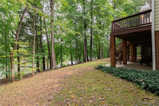 view of yard featuring a patio and a deck