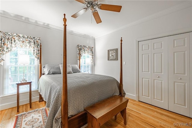 bedroom with multiple windows, crown molding, and light wood-type flooring