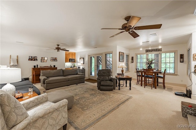 living room featuring light colored carpet and ceiling fan