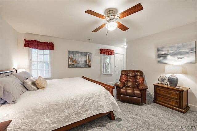 bedroom featuring light carpet, a closet, and ceiling fan