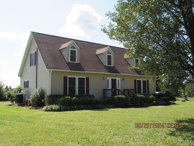 cape cod-style house featuring a front lawn and central AC