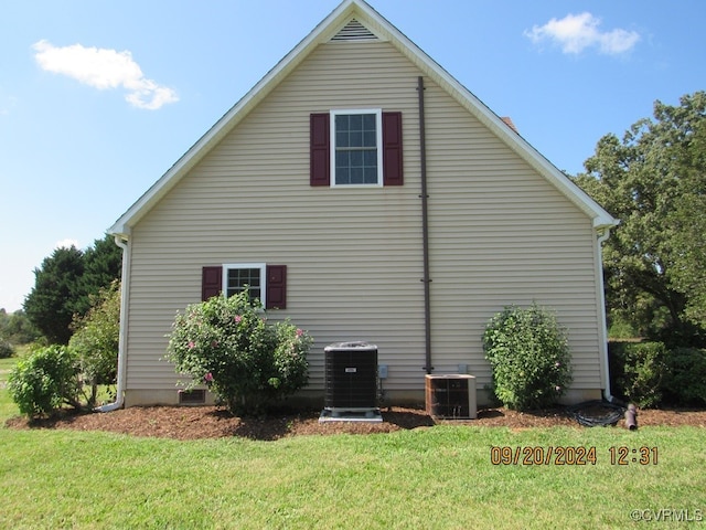 view of property exterior featuring a yard and central AC