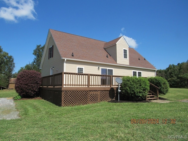 back of property featuring a deck and a yard