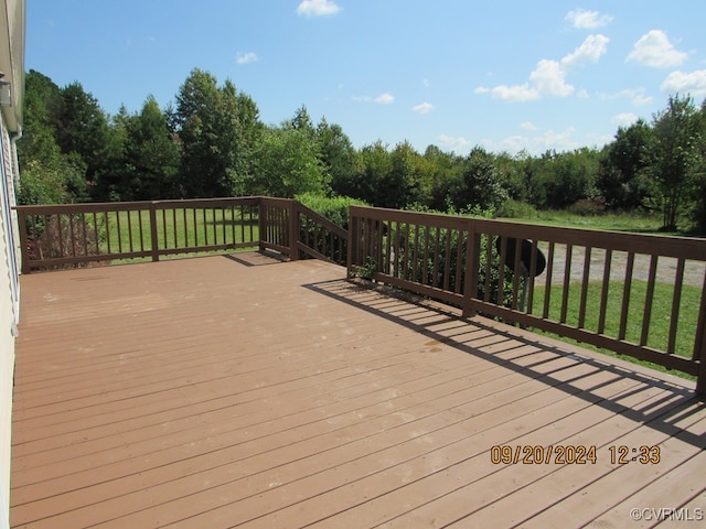 wooden deck featuring a yard