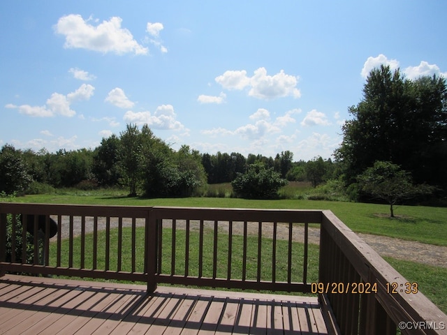 wooden deck featuring a lawn