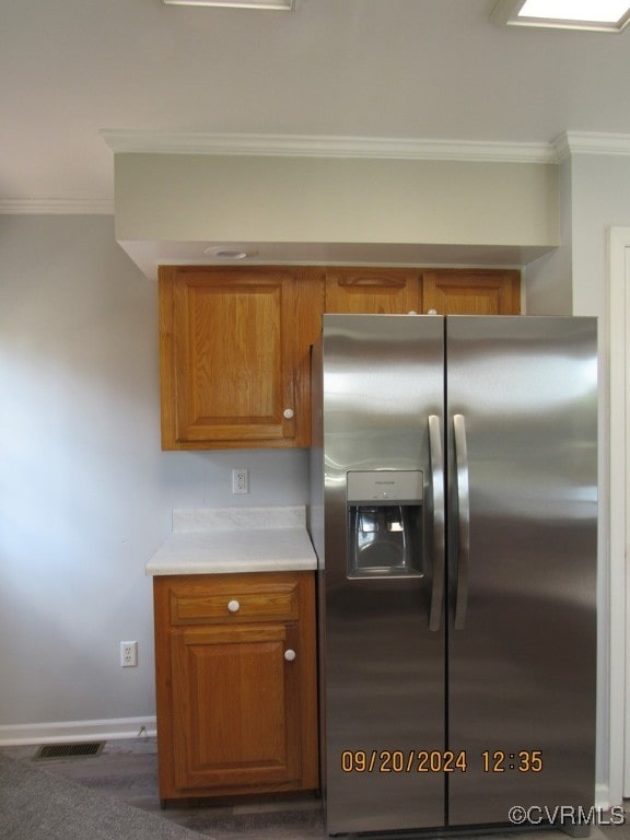 kitchen with stainless steel fridge, ornamental molding, and dark hardwood / wood-style floors