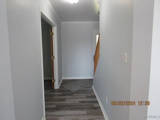 corridor with ornamental molding and dark wood-type flooring