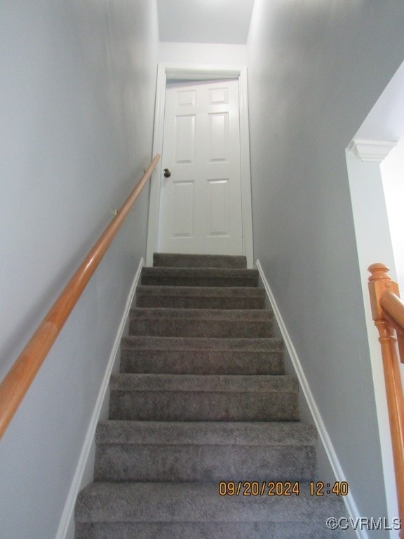 stairs featuring wood-type flooring