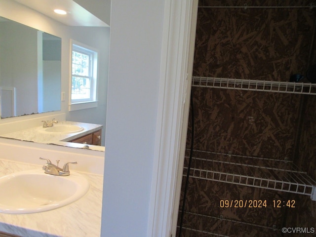 bathroom with a shower and vanity