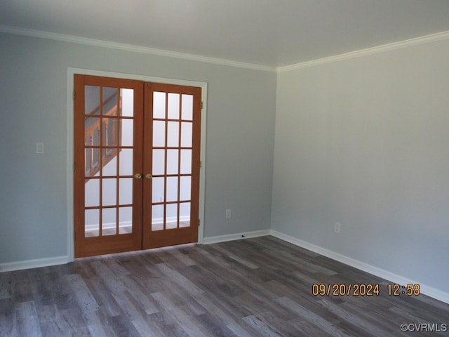 empty room featuring ornamental molding, dark hardwood / wood-style floors, and french doors