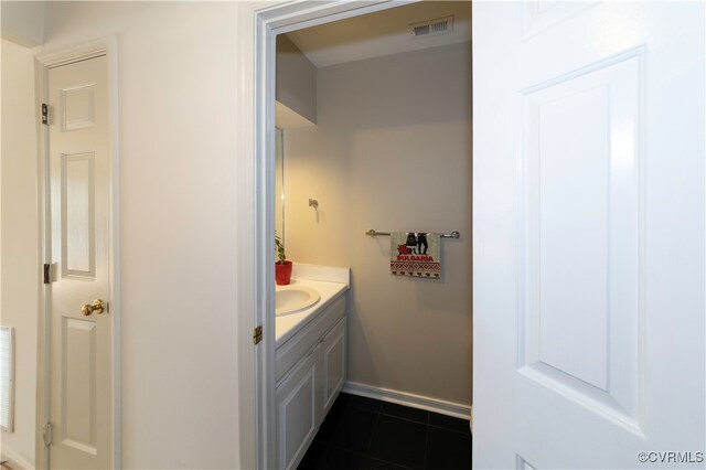 bathroom featuring tile patterned flooring and vanity