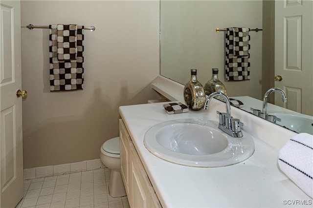 bathroom featuring tile patterned flooring, vanity, and toilet