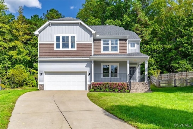 view of front facade featuring covered porch, a garage, and a front lawn