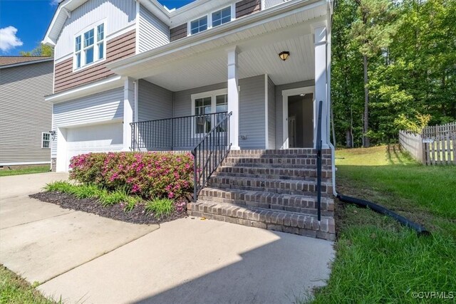 doorway to property featuring a garage and covered porch