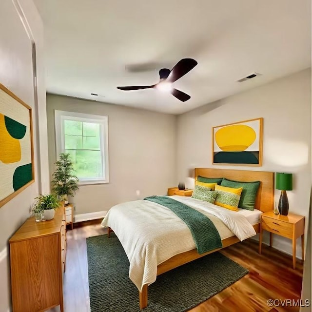 bedroom with ceiling fan and dark wood-type flooring