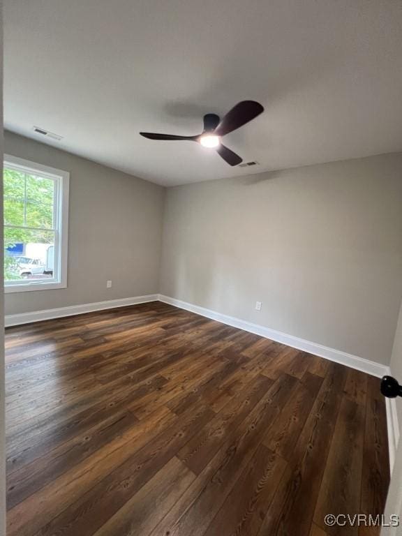 empty room featuring dark hardwood / wood-style floors and ceiling fan