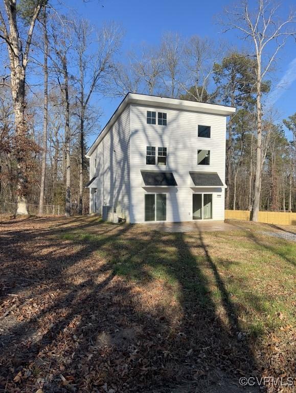 rear view of property with a lawn