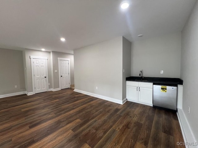 bar with dishwasher, white cabinets, dark wood-type flooring, and sink