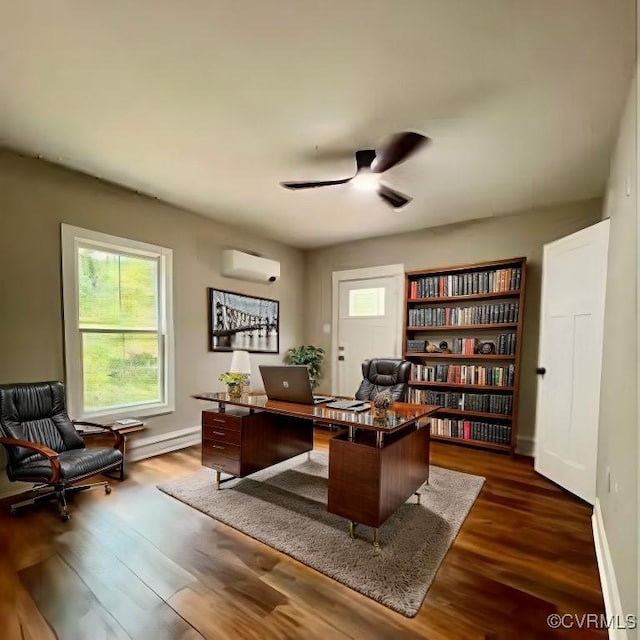 home office with a wall mounted air conditioner, ceiling fan, and dark wood-type flooring