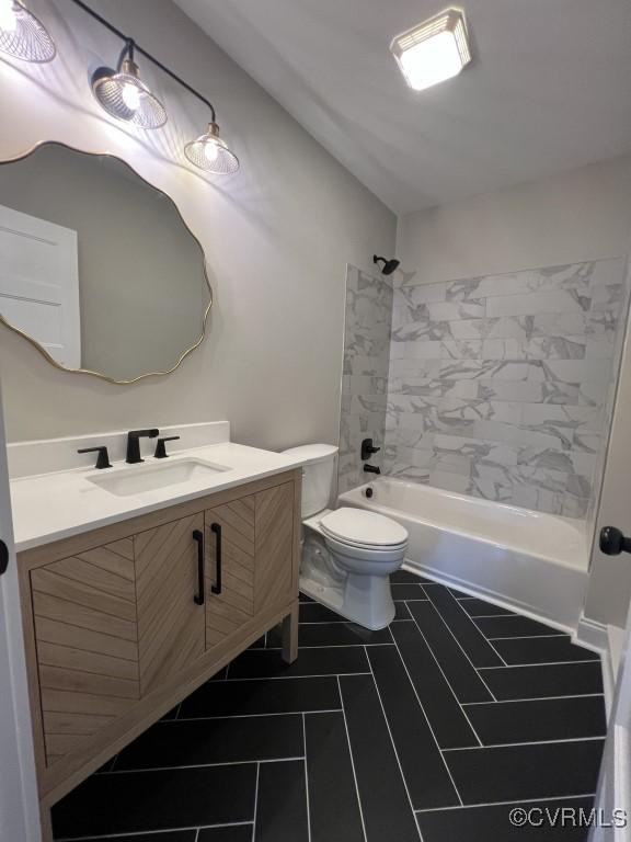 full bathroom featuring vanity, toilet, and tiled shower / bath