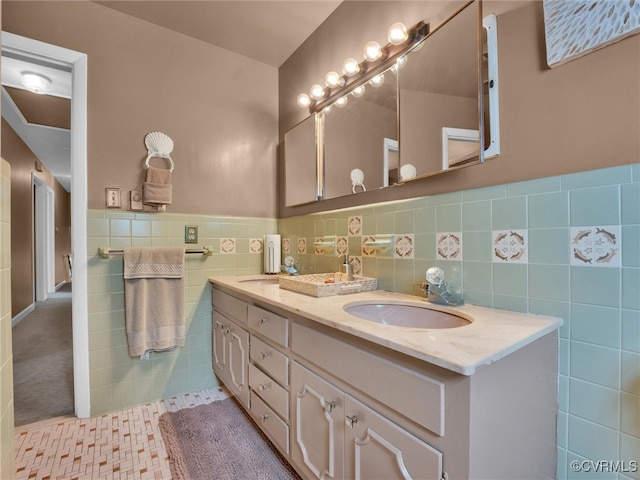 bathroom with tile patterned flooring, vanity, and tile walls