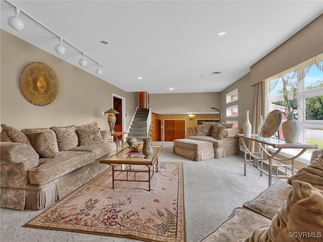 living room with light carpet and rail lighting