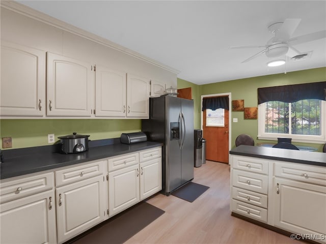 kitchen featuring light wood-type flooring, stainless steel fridge with ice dispenser, ceiling fan, and white cabinetry